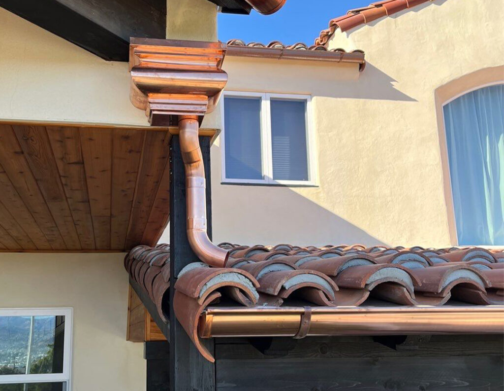 Collection of rain gutter accessories including hangers, end caps, and downspout components, used in seamless gutter installation San Diego for complete home protection.