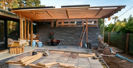 Aquasoltech Firefly patio cover installation in progress on a San Diego home, showing partially assembled aluminum patio structure and support posts during outdoor improvement work.