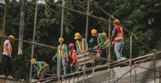 Aquasoltech team installing a seamless gutter system and aluminum patio cover on a residential home in San Diego, showing professional exterior installation in progress for enhanced rainwater management and outdoor living space.
