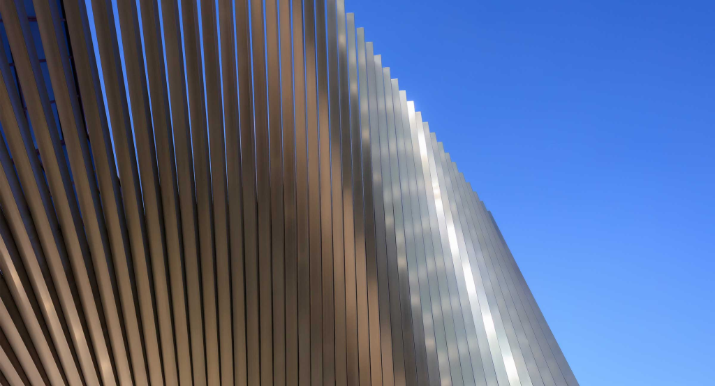 Architectural metal design elements displayed in a modern outdoor setting by Aquasoltech, highlighting creative uses of sheet metal for structural accents and contemporary design features.