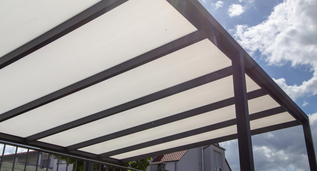 Aquasoltech professional cleaning and maintaining a custom aluminum patio cover in San Diego, demonstrating proper patio cover upkeep to extend its lifespan and keep outdoor spaces looking their best.